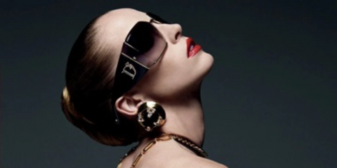 Abby Champion was seen modeling black and gold Dsquared2 D2 0154/S 0009O sunglasses with grey gradient lenses in the brand's Fall/Winter 2024 eyewear campaign