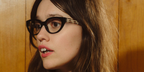 Aimee Lou Wood was seen wearing black Versace 3383 GB1 cat eye optical glasses in the Versace Greca Eyewear campaign, October 2025.