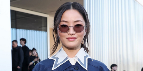 Anna Sawai was seen wearing pecan Prada PR B56S 24E20I round sunglasses with pink brown lenses at the Prada Fall/Winter 2026 fashion show during Milan Fashion Week.