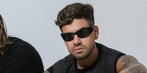 Italian DJ and record producer Matteo Milleri, widely known as Anyma, was seen wearing black Prada PR A19S 1AB5S0  wraparound sunglasses.