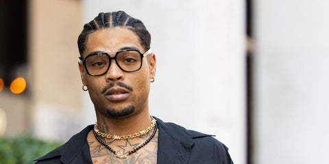 Italian rapper Artie 5ive was seen wearing black Saint Laurent SL 545 001 aviator sunglasses at the Vivienne Westwood Menswear Spring/Summer 2026 fashion show during Milan Men's Fashion Week.
