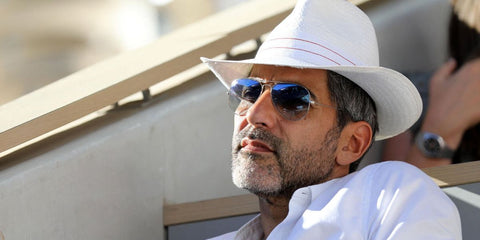 French actor and comedian Ary Abittan was seen wearing silver Ray-Ban Aviator 3025 003/3F sunglasses with blue gradient lenses at the 2021 French Open Tennis Championships