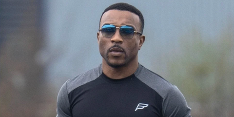 Rapper and actor Ashley Walters was seen wearing black and gold Ray-Ban RB 3683 9000/3F sunglasses with blue to grey gradient lenses in March 2025.
