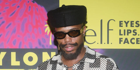 B.o.B was seen wearing black Miu Miu MU 11WS 16K10R sunglasses with yellow lenses  the NYLON House during Miami Art Week in December 2025.