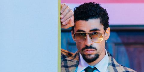 Bad Bunny was seen wearing gold Miu Miu MU A56S 5AK90L sunglasses with brown gradient lenses on the cover of Billboard magazine, October 2025.