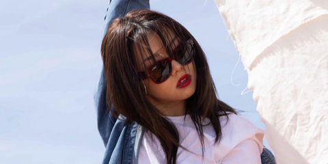 Singer, rapper, and dancer Bailey Sok was seen wearing transparent red Ray-Ban Mega Wayfarer RB 0840S 6679/B1 sunglasses in a Ray-Ban campaign, August 2023.