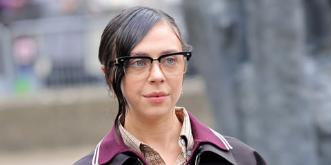 Actress Bel Powley was seen wearing black and gold Miu Miu MU 10ZS 1AB08N Blue Control half-rim optical glasses at the Miu Miu Fall/Winter 2024 fashion show during Paris Fashion Week