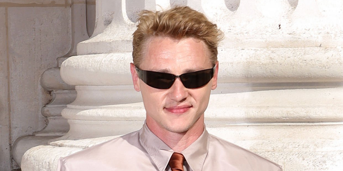 Ben Hardy was seen wearing black Saint Laurent Sun SL 963 001 wraparound sunglasses at the Saint Laurent Menswear Spring/Summer 2027 fashion show during Paris Men's Fashion Week
