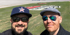 Bill Burr, pictured on the right with fellow comedian Nate Bargatze, was seen wearing gold Ray-Ban Aviator 3025 112/17 Blue Flash Mirror sunglasses at an NASCAR event, shared on Nate Bargatze's Twitter / X post. Shop online now on Pretavoir