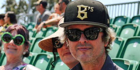 Billy Joe Armstrong of the punk rock band Green Day was seen wearing black Ray-Ban State Street RB 2186 901/31 sunglasses at the Oakland Ballers game, July 2024. Shop online now on Pretavoir