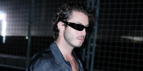 Turkish actor Boran Kuzum was seen wearing black Prada PR A19S 1AB5S0 wraparound sunglasses in Austin, Texas, shared through his Instagram post in October 2024.