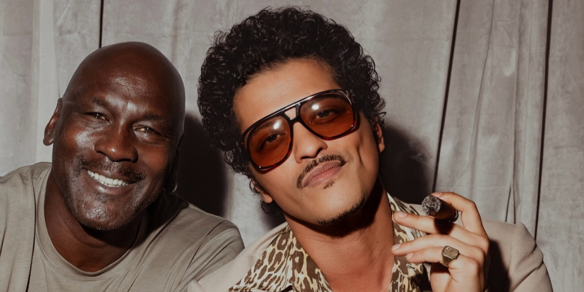 Bruno Mars, pictured with Michael Jordan, was seen wearing tortoise Saint Laurent Sun SL 596 Dune 003 aviator sunglasses with light brown lenses during his The Romantic Tour in Milan, Italy, July 2026