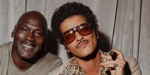 Bruno Mars, pictured with Michael Jordan, was seen wearing tortoise Saint Laurent Sun SL 596 Dune 003 aviator sunglasses with light brown lenses during his The Romantic Tour in Milan, Italy, July 2026