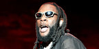 Burna Boy was seen wearing ruthenium Balenciaga BB0229S 002 sunglasses at the 2023 Dreamville Music festival in Raleigh, North Carolina