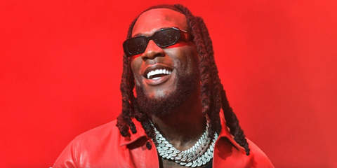 Burna Boy was seen wearing black Prada PR 17WS 1AB5S0 Symbole Sunglasses