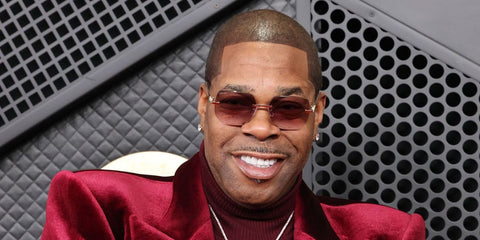 Busta Rhymes was seen wearing gold Cartier Panthere CT0549S 004 rimless sunglasses with red purple gradient lenses at the Grammy Awards 2026.