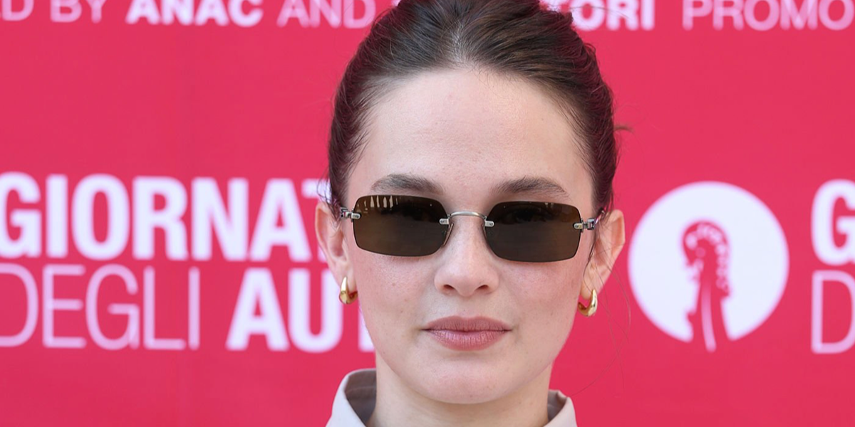 Cailee Spaeny was seen wearing Miu Miu MU B50S 26C09Z rimless sunglasses with dark brown lenses at the Miu Miu Women's Tales during Venice Film Festival 2026.