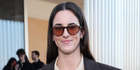 Professional basketball player Caitlin Clark  was seen wearing transparent clay Prada PR B15S 28I50W sunglasses with pink lenses at the Prada Fall/Winter 2026 fashion show during Milan Fashion Week.