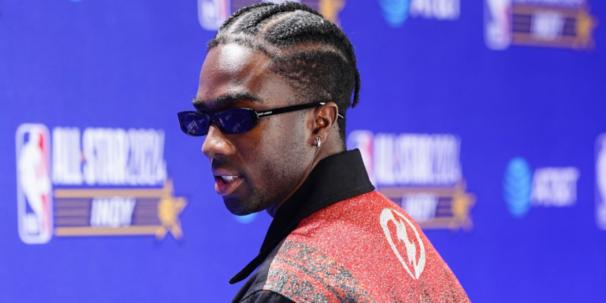 Caleb McLaughlin was seen wearing black Saint Laurent Sun SL 557 Shade 001 slim sunglasses during the NBA All-Star Game-VIP Blue Carpet Arrivals