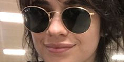 Camila Cabello was seen wearing gold Ray-Ban Round Metal RB 3447 001/58 sunglasses with green Polarised lenses.