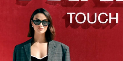 Camila Mendes was seen wearing black Prada PR B15S 16K731 sunglasses at a Prada Beauty event in Miami, April 2026.