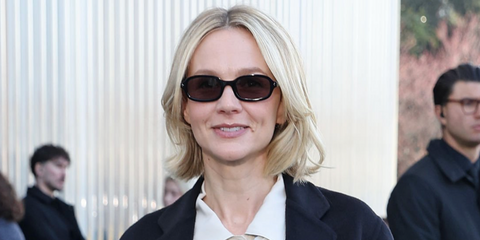 Celebrity actress Carey Mulligan was seen wearing new Prada PR D06S 16K03D round rectangular sunglasses in black with grey lenses at the Prada Fall/Winter 2026 show during Milan Fashion Week.