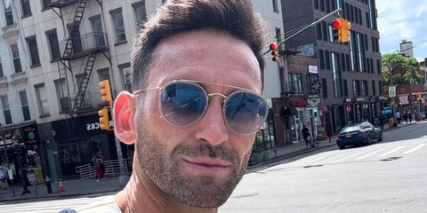 Television personality Carl Radke was seen wearing gold and transparent Ray-Ban Double Bridge RB 3647N 9123/3M sunglasses with blue gradient lenses in his Instagram post, May 2025.