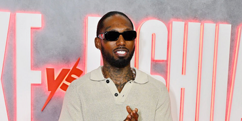 Rapper Castillo was seen wearing black Prada PR 17WS 1AB5S0 Symbole Sunglasses at the Jake Paul vs Anthony Joshua Netflix Live Event in Miami, December 2025.