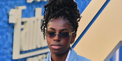 Singer-songwriter Cat Burns was seen wearing gold Miu Miu MU A51S 5AK50K rimless sunglasses with grey lenses at the UK launch of "The Fantastic Four: First Steps"in London, July 2025. Shop online now on Pretavoir