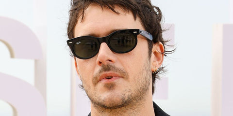 French actor Cesar Domboy was seen wearing black Ray-Ban Wayfarer Oval RB 2242 901/31 sunglasses at the 8th Canneseries International Festival. Shop online now on Pretavoir