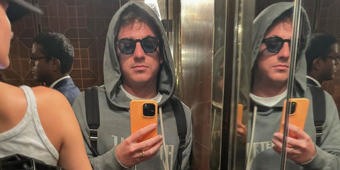 Charlie Puth was seen wearing black Prada PR A16S 16K04D sunglasses with blue Polarised lenses in his Instagram post, December 2024