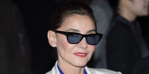 French actress Clotilde Courau was seen wearing black Tom Ford Penn-02 TF1362 01V sunglasses with blue lenses at the Tom Ford Fall/Winter 2026 fashion show during Paris Fashion Week.
