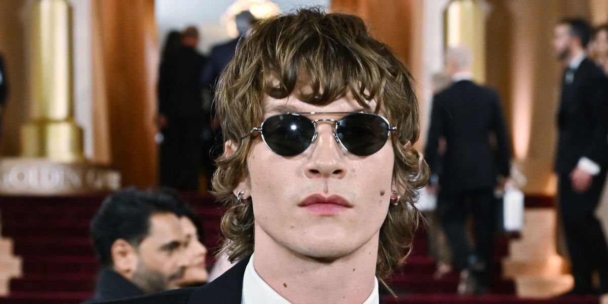 Heated Rivalry star Connor Storrie was seen wearing silver Saint Laurent Sun SL 97 002 sunglasses at the Golden Globes 2026.