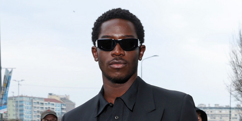 Damson Idris was seen wearing black Prada PR B19S 16K08Z sunglasses at the Prada Menswear Fall/Winter 2026 fashion show during Milan Men's Fashion Week.