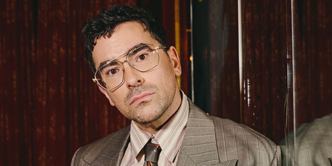 Dan Levy was seen wearing gold Versace 1307 1002 geometric-shaped optical glasses at the New York premiere of Netflix's crime comedy series "Big Mistakes" in April 2026.