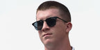 Racing driver Daniel Dye was seen wearing matte black Ray-Ban RB 3716 186/R5 sunglasses with blue lenses in his Instagram post, May 2025.