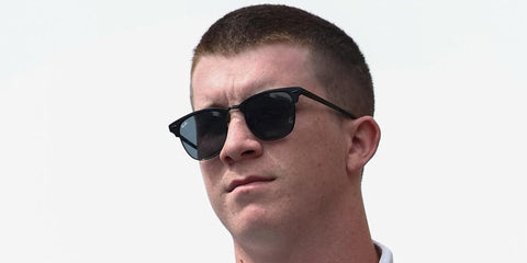 Racing driver Daniel Dye was seen wearing matte black Ray-Ban RB 3716 186/R5 sunglasses with blue lenses in his Instagram post, May 2025.