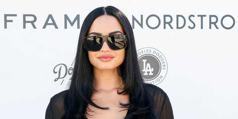 Demi Lovato was seen wearing black Saint Laurent Sun SL 832 001 sunglasses at the Baby2Baby Holiday Distribution in Los Angeles, December 2025.