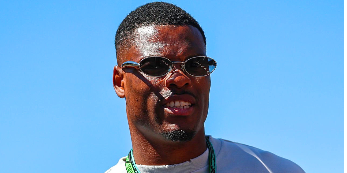 Dutch footballer Denzel Dumfries was seen wearing silver Bottega Veneta BV1386S 007 Sardine oval sunglasses with grey mirror lenses at the F1 Spanish Grand Prix 2026.