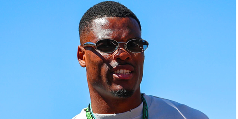Dutch footballer Denzel Dumfries was seen wearing silver Bottega Veneta BV1386S 007 Sardine oval sunglasses with grey mirror lenses at the F1 Spanish Grand Prix 2026.