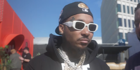 Rapper Doe Boy was seen wearing white Prada PR 17WS 1425S0 Symbole sunglasses at the Rolling Loud Festival 2024.
