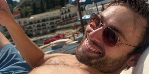 Actor Douglas Booth was seen wearing copper Ray-Ban Hexagonal RB 3548N 9069/A5 sunglasses with pink to brown gradient lenses in Sicily, June 2025. Shop online now on Pretavoir