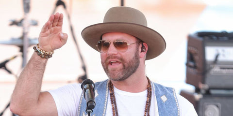 American country singer Drake White was seen wearing Ray-Ban Aviator 3025 001/51 Gold/Light Brown Gradient sunglasses at the CMA Fest 2022 in Nashville, Tennessee.