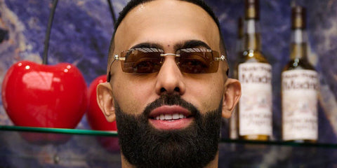 Puerto Rican rapper and singer Eladio Carrion was seen wearing gold Cartier Panthere CT0505S 003 sunglasses with brown lenses at his signing event in Madrid, April 2025. Shop online now on Pretavoir