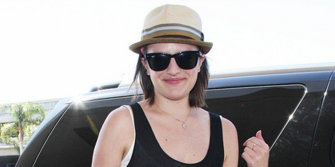 Actress Elisabeth Moss was seen wearing black Ray-Ban Folding Wayfarer 4105 601 sunglasses at LAX in July 2014.