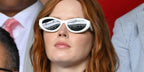 Ellie Bamber was seen wearing talc white Prada PR 26ZS 17K08Z cat eye sunglasses at the 2023 Wimbledon Tennis Championships
