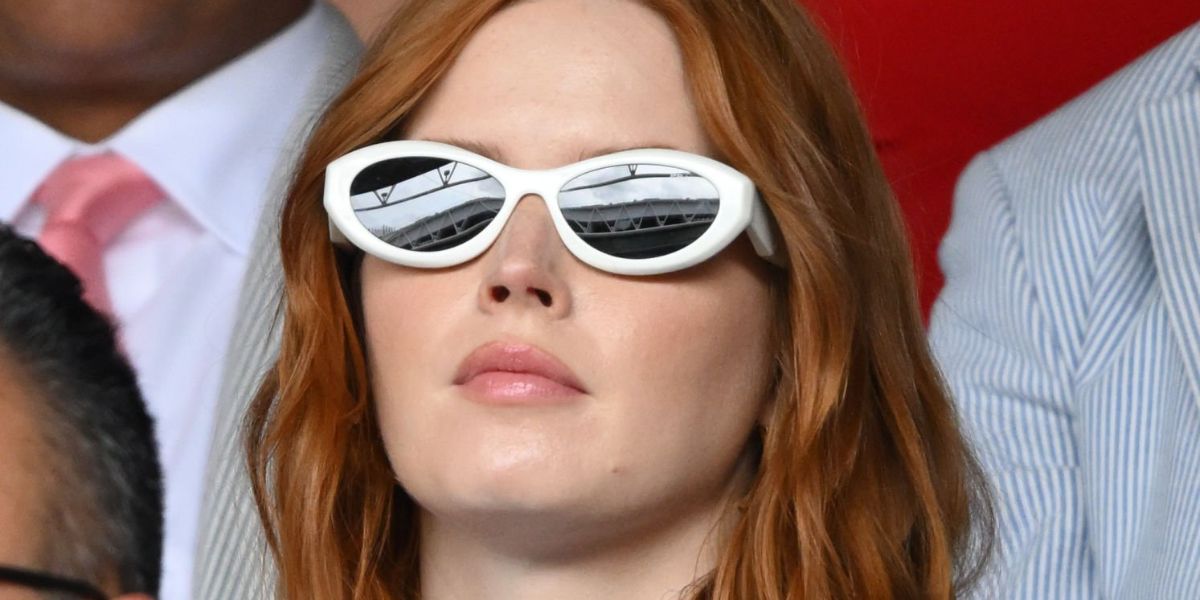 Ellie Bamber was seen wearing talc white Prada PR 26ZS 17K08Z cat eye sunglasses at the 2023 Wimbledon Tennis Championships