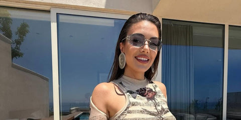 Albanian singer Elvana Gjata was seen wearing pale gold Miu Miu MU A51S ZVN10P sunglasses with blue lenses in her Instagram post, July 2025.