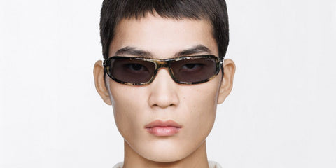 Male model wears Tom Ford Addison-02 TF1400 56A honey havana wraparound sunglasses