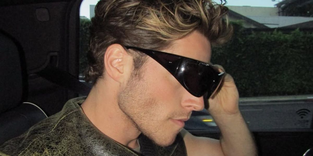 Froy Gutierrez was seen wearing black Givenchy GV40051I 01A wraparound sunglasses to attend the Givenchy Spring/Summer 2024 fashion show during Paris Men's Fashion Week